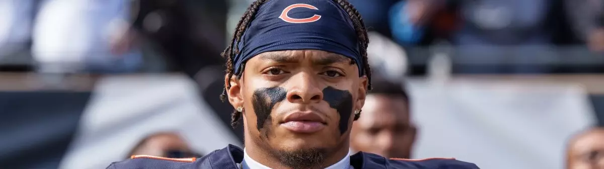 Justin Fields injury worries Bears. On frame, Fields with a focused look and thoughtful expression.